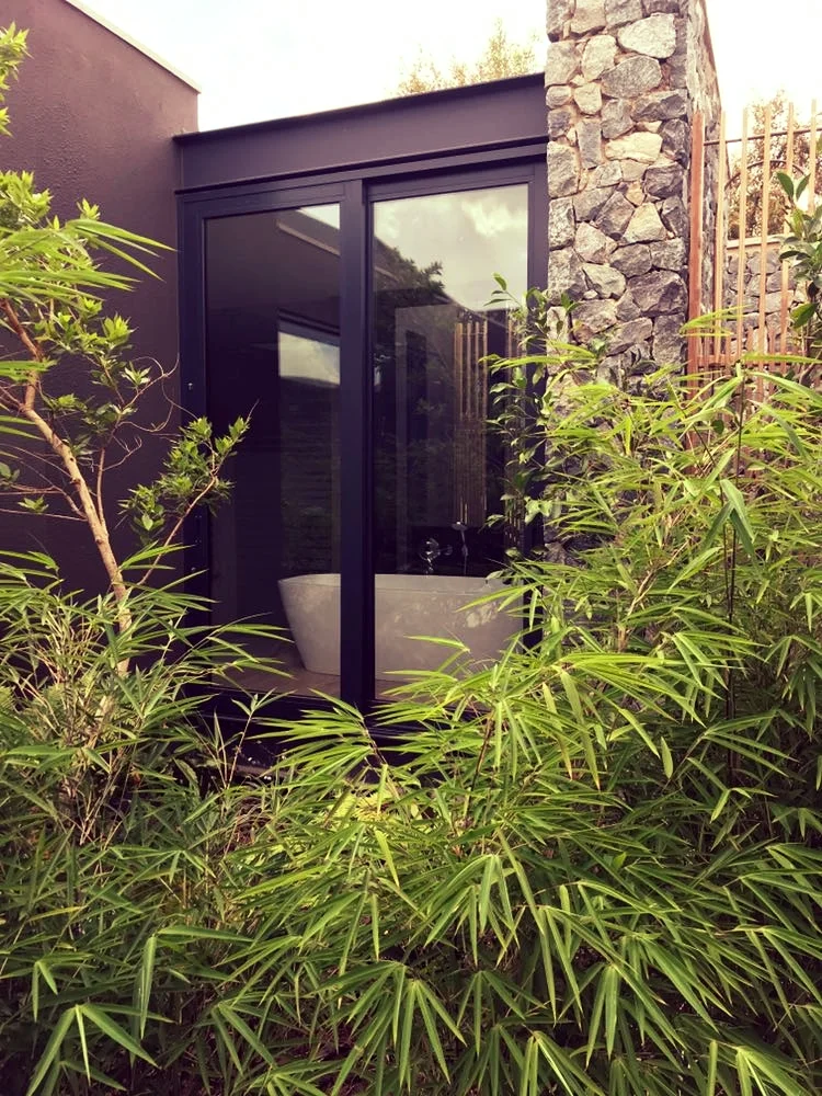 Amoretti glazing and joinery installation with a freestanding bath and bamboo courtyard