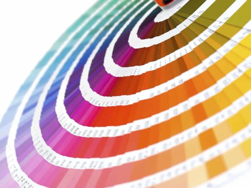 Pantone colour matching book fanned open showing a range of finish colours