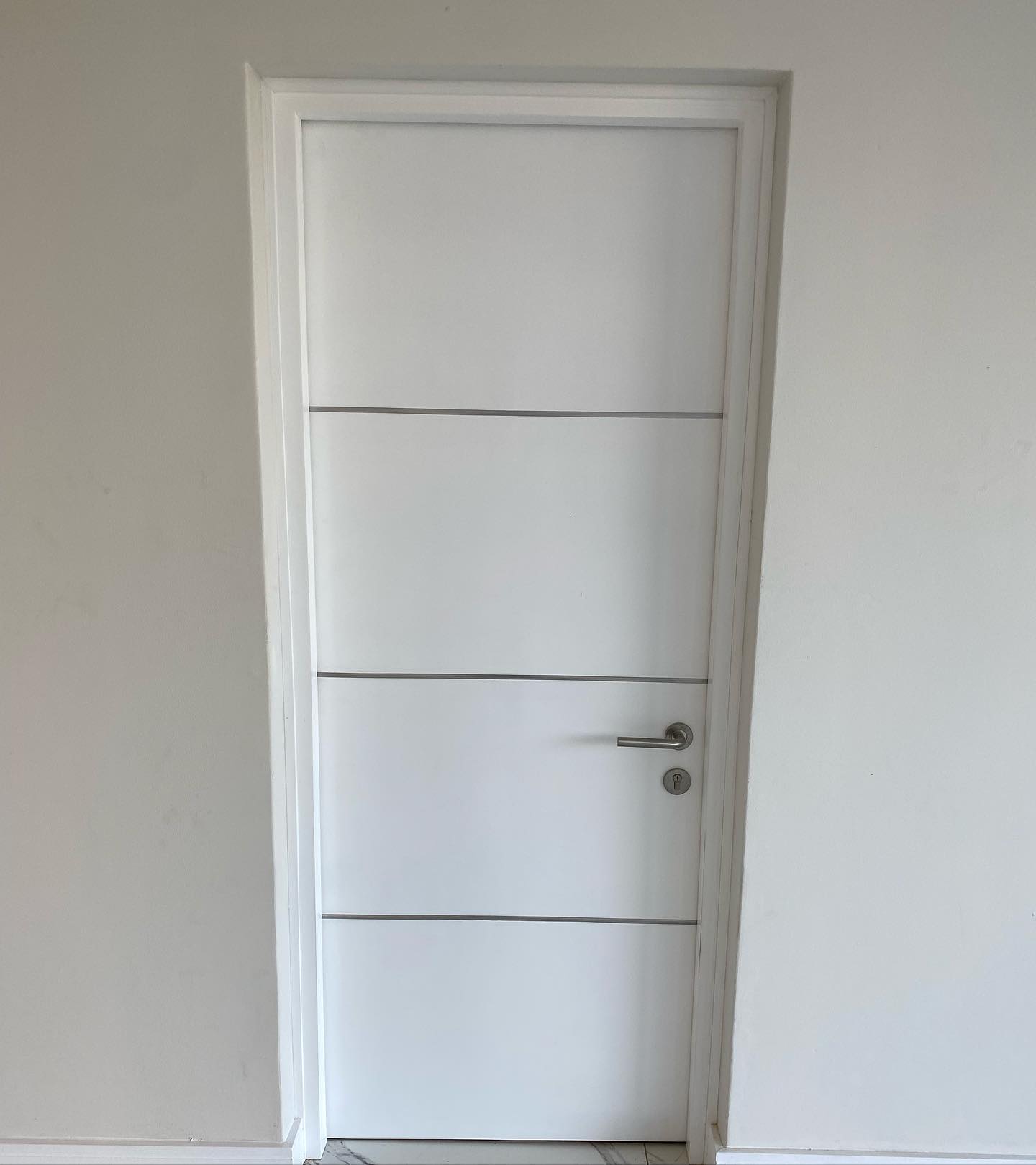 Simple white lined flush door, closed