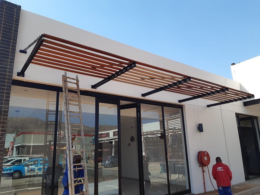 Timber louvre canopy installation above a shopfront