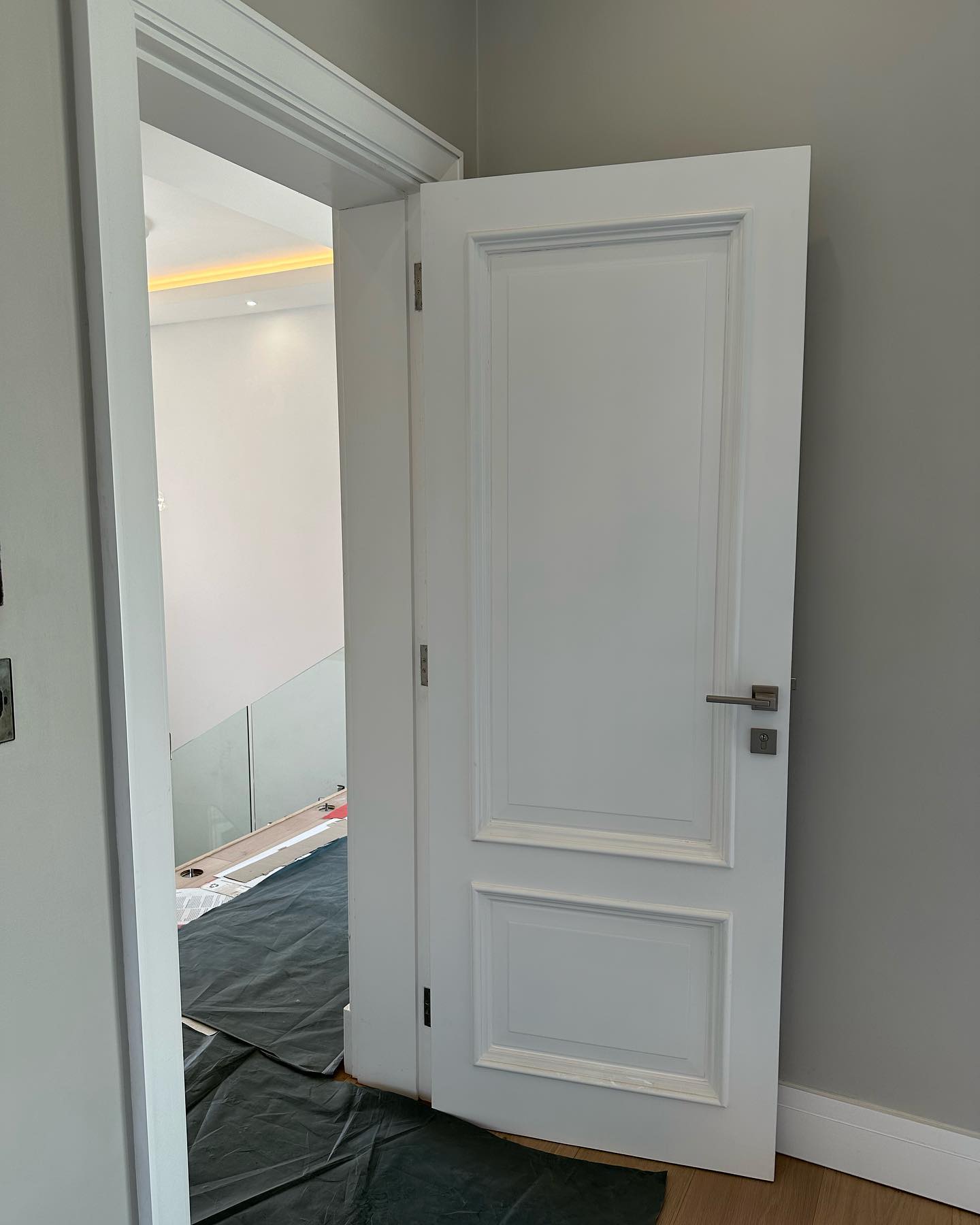 Traditional white panel door open onto a stairwell landing