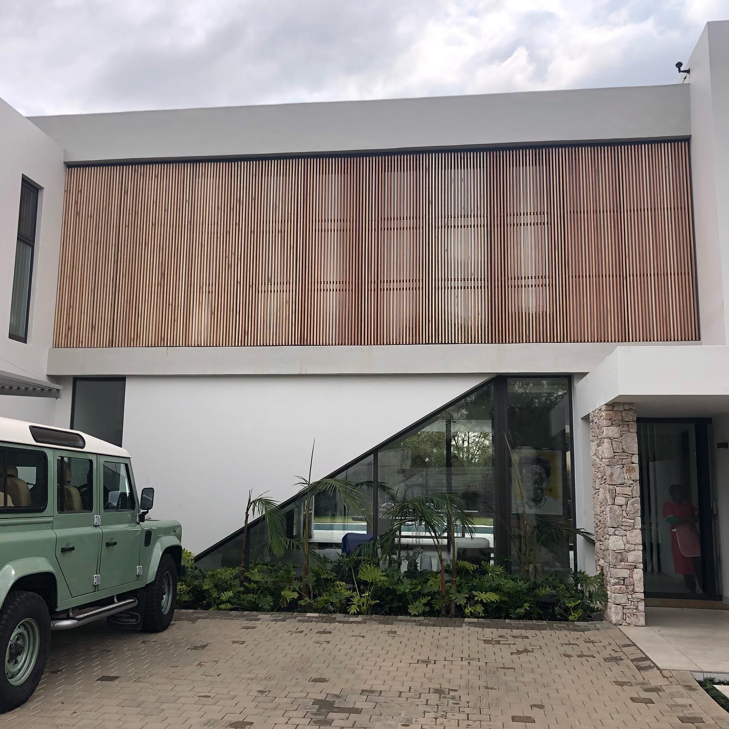 Exterior timber slat facade above ground-floor glazing