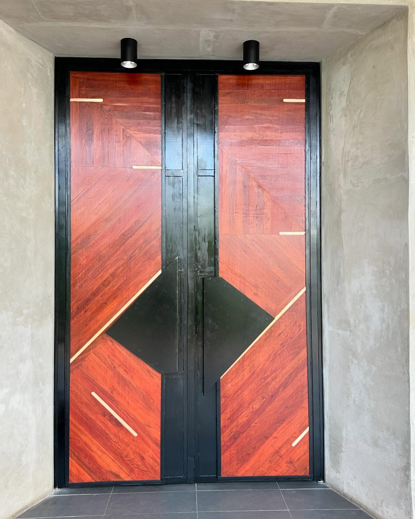 Bespoke geometric marquetry double door with black steel banding