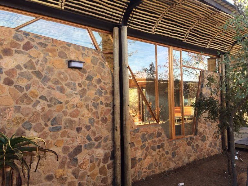 Bush Residence timber window with one pane shown propped open