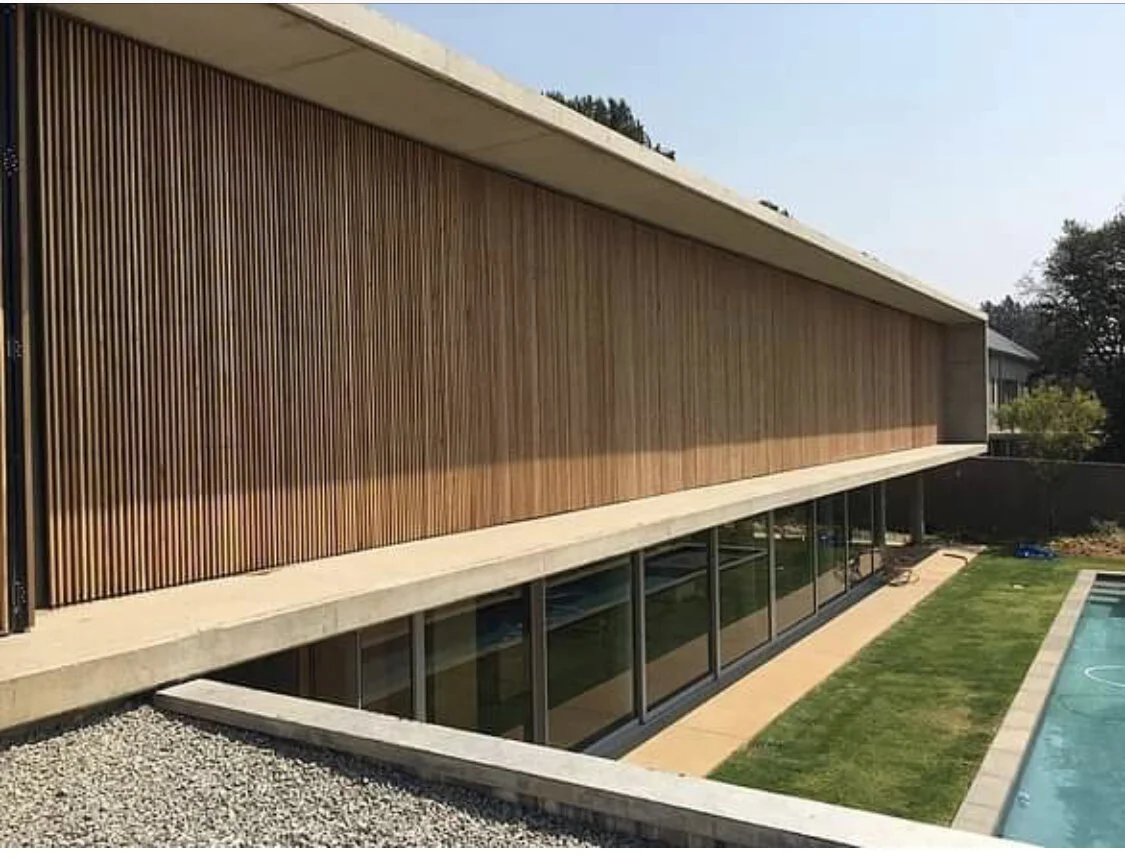 Vertical timber privacy screen used as a decorative facade element