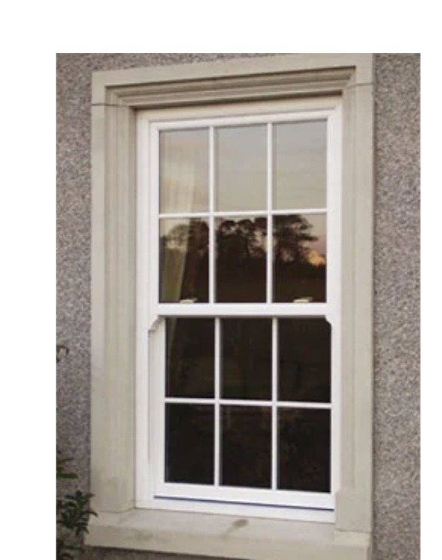 Traditional timber sliding sash window in a stone surround